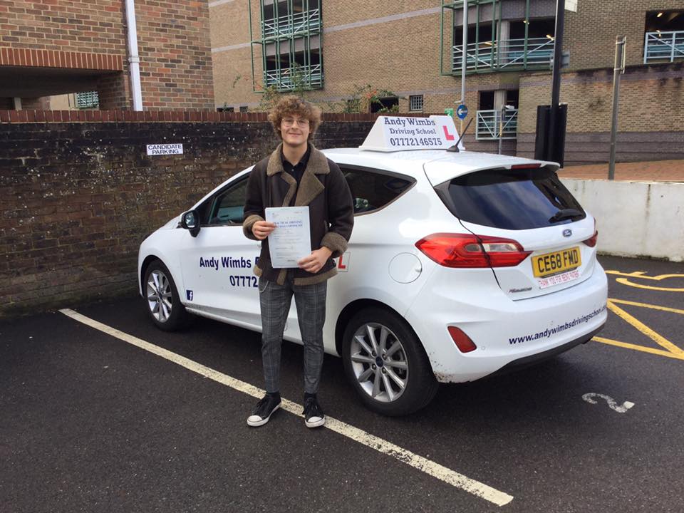 Teen boy holding his pass certificate for driving